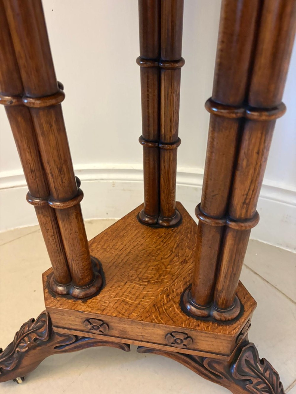 An antique Regency hexagonal pollard oak side table with turned column legs and a carved tripod base on castors. View VI