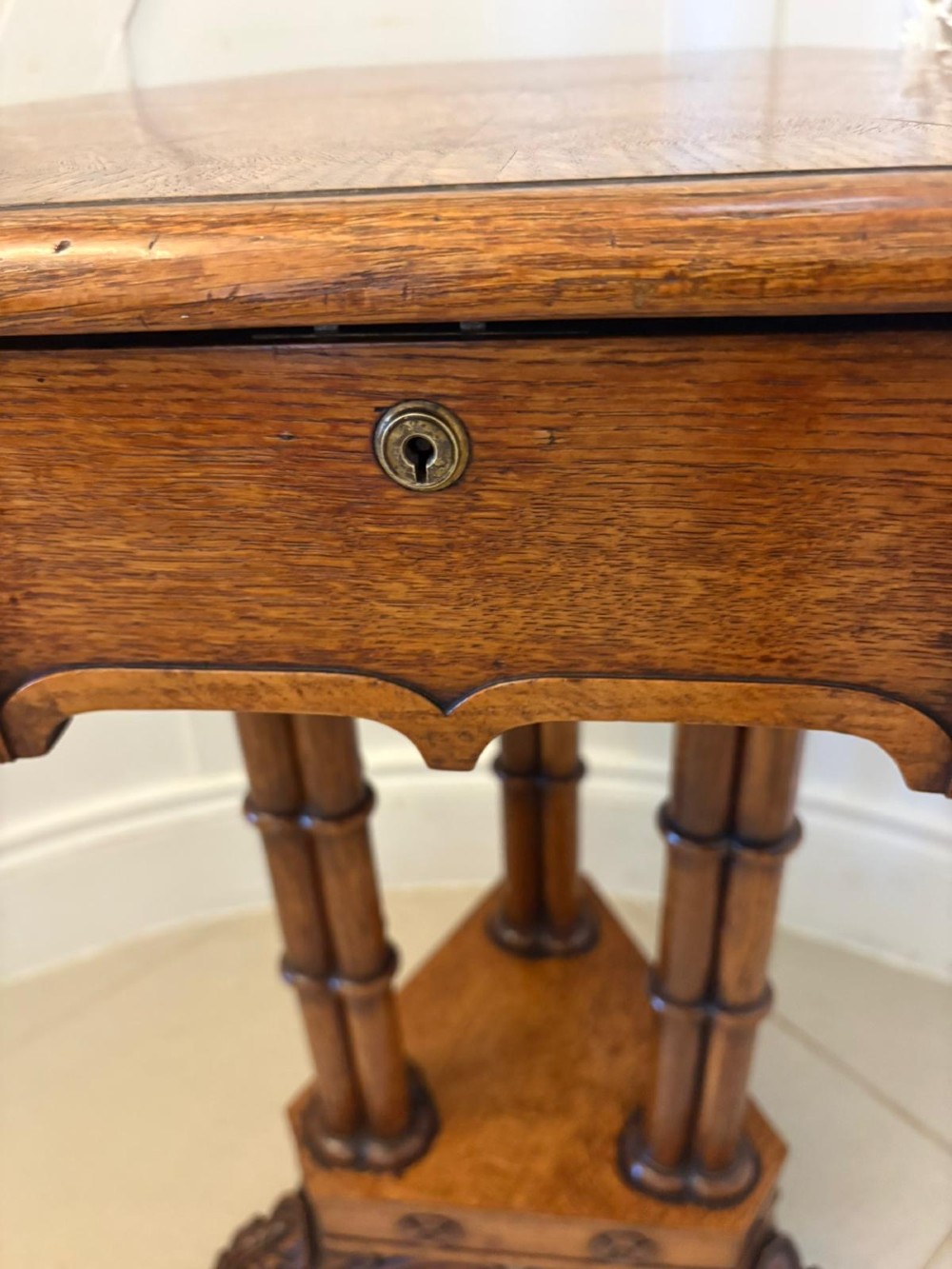 An antique Regency hexagonal pollard oak side table with turned column legs and a carved tripod base on castors. View IX