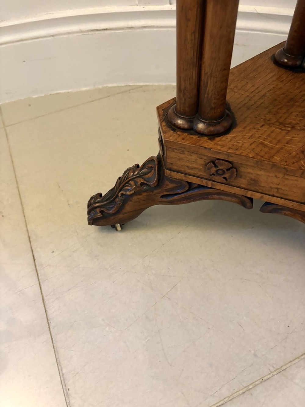 An antique Regency hexagonal pollard oak side table with turned column legs and a carved tripod base on castors. View XII