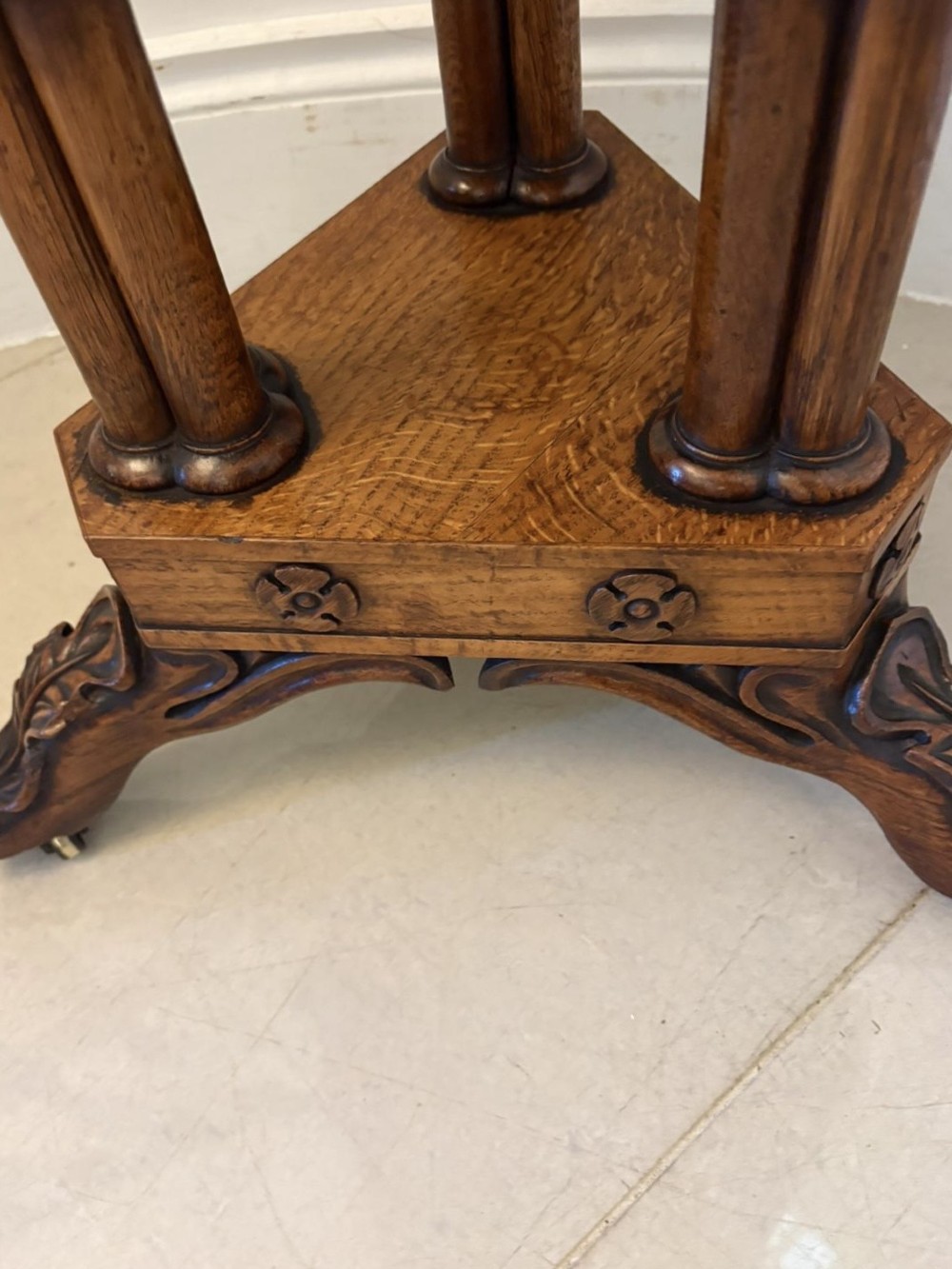 An antique Regency hexagonal pollard oak side table with turned column legs and a carved tripod base on castors. View XIII