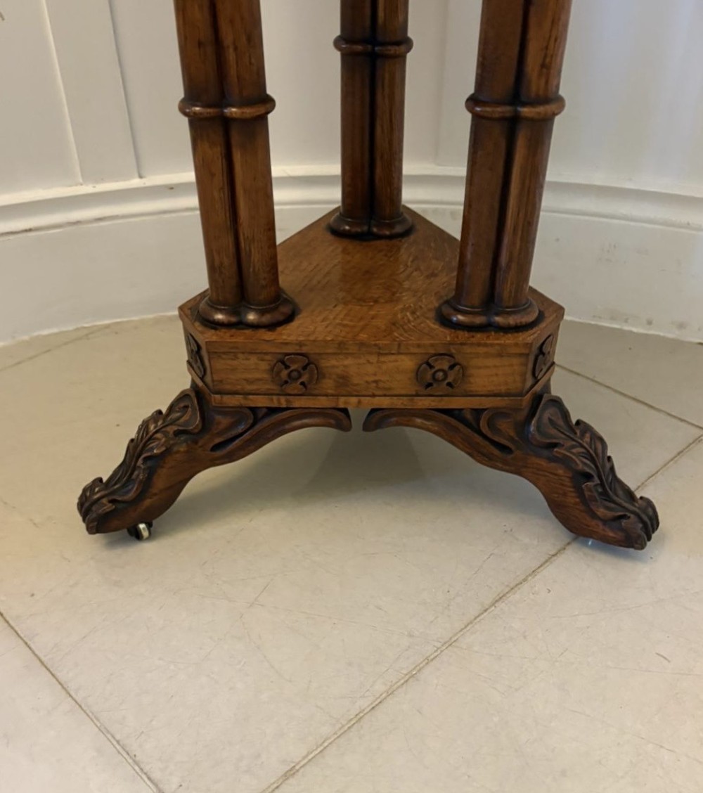 An antique Regency hexagonal pollard oak side table with turned column legs and a carved tripod base on castors. View XIV