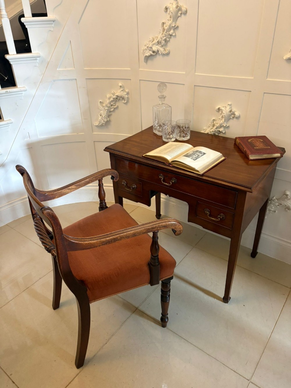 An antique Georgian mahogany lowboy hall table featuring three drawers with brass swan-neck handles and straight square legs. View IV