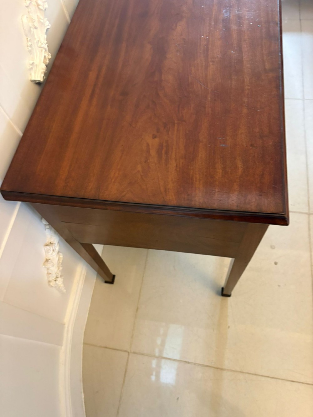 An antique Georgian mahogany lowboy hall table featuring three drawers with brass swan-neck handles and straight square legs. View VIII