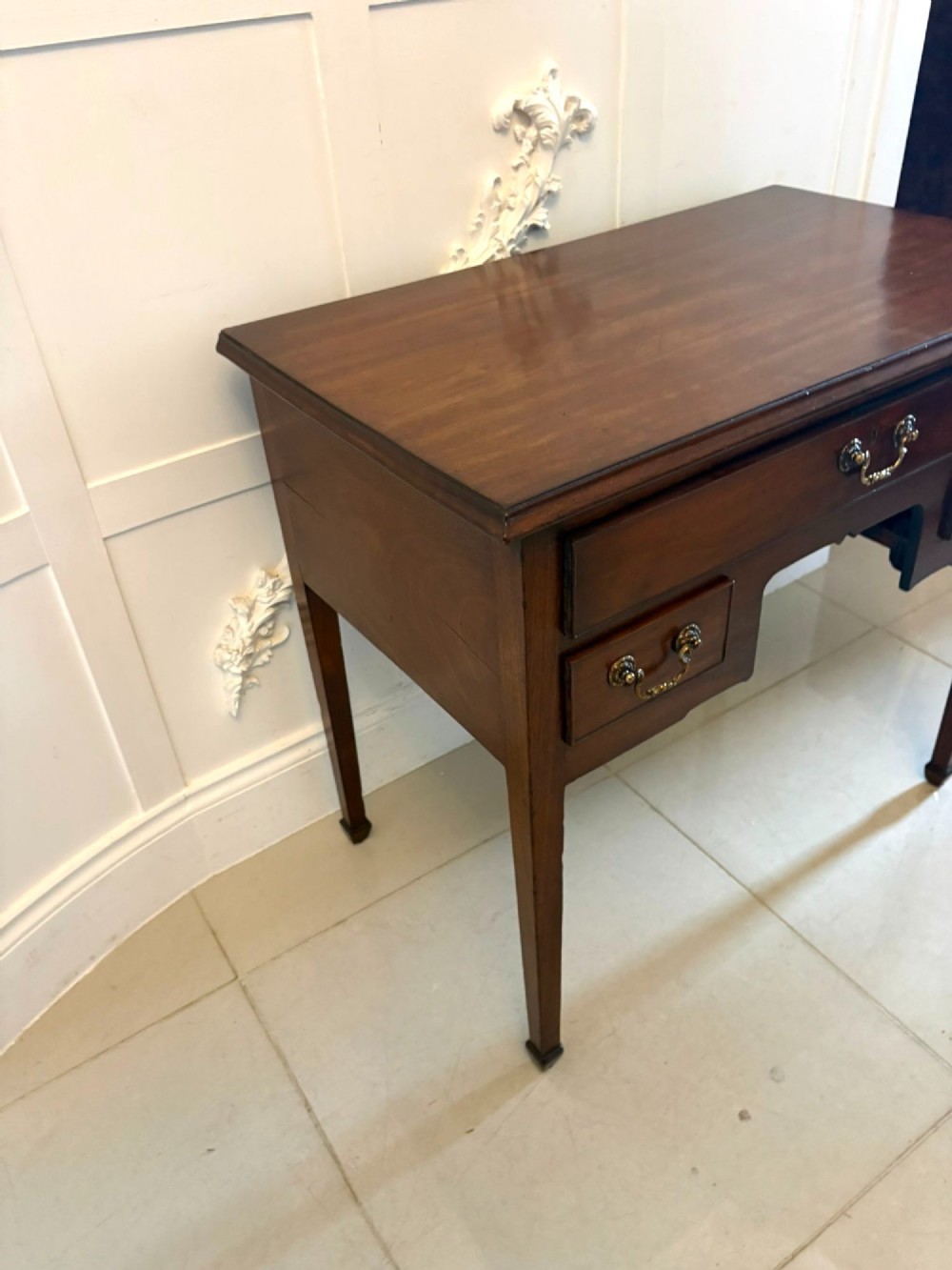 An antique Georgian mahogany lowboy hall table featuring three drawers with brass swan-neck handles and straight square legs. View XII