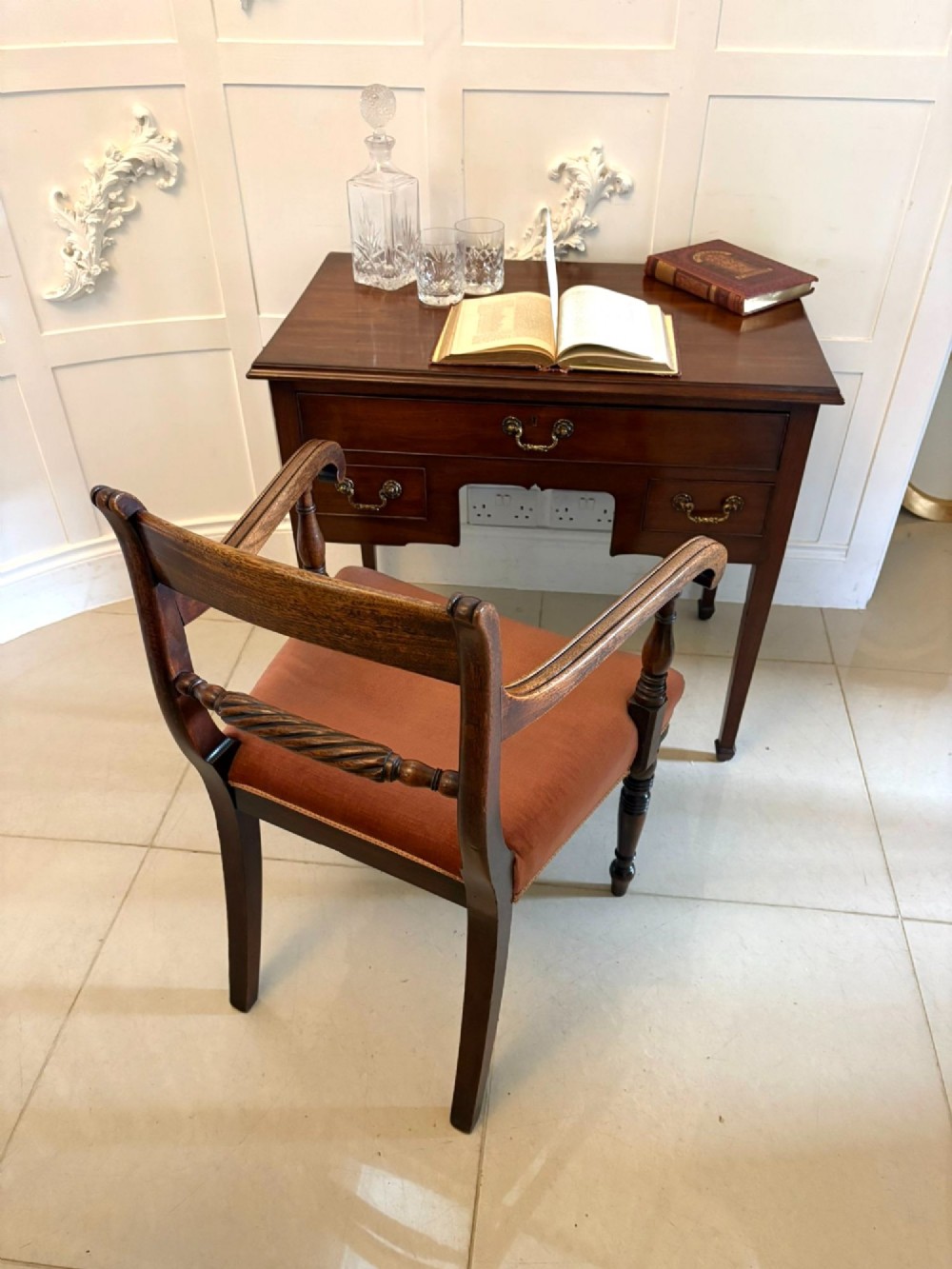 An antique Georgian mahogany lowboy hall table featuring three drawers with brass swan-neck handles and straight square legs. View XIII
