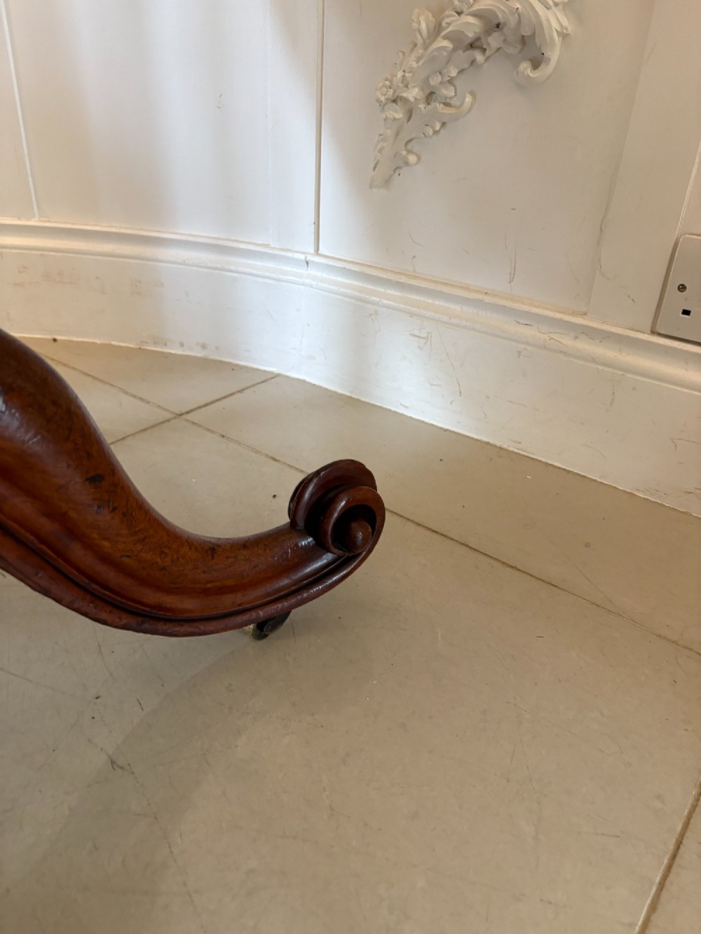 An oval Victorian tilt-top dining table in figured mahogany with satinwood crossbanding, set on a quadruped pedestal base with brass castors. View VIII