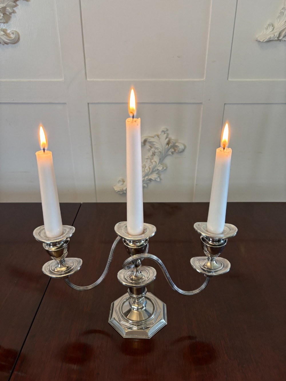 A matching pair of Edwardian silver plated three-light candelabras with octagonal bases and curved reeded arms. View III