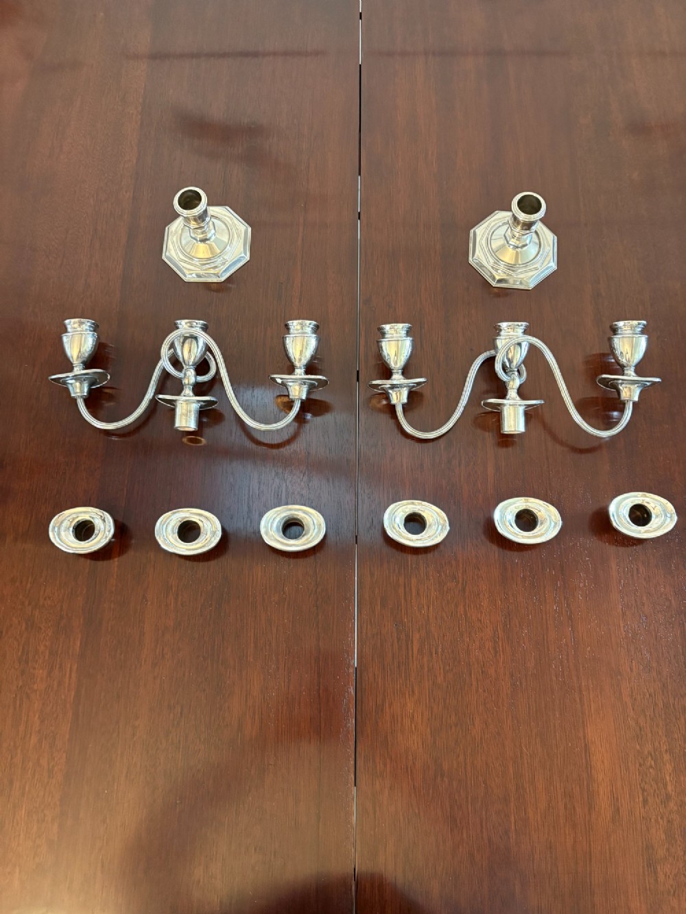 A matching pair of Edwardian silver plated three-light candelabras with octagonal bases and curved reeded arms. View VI