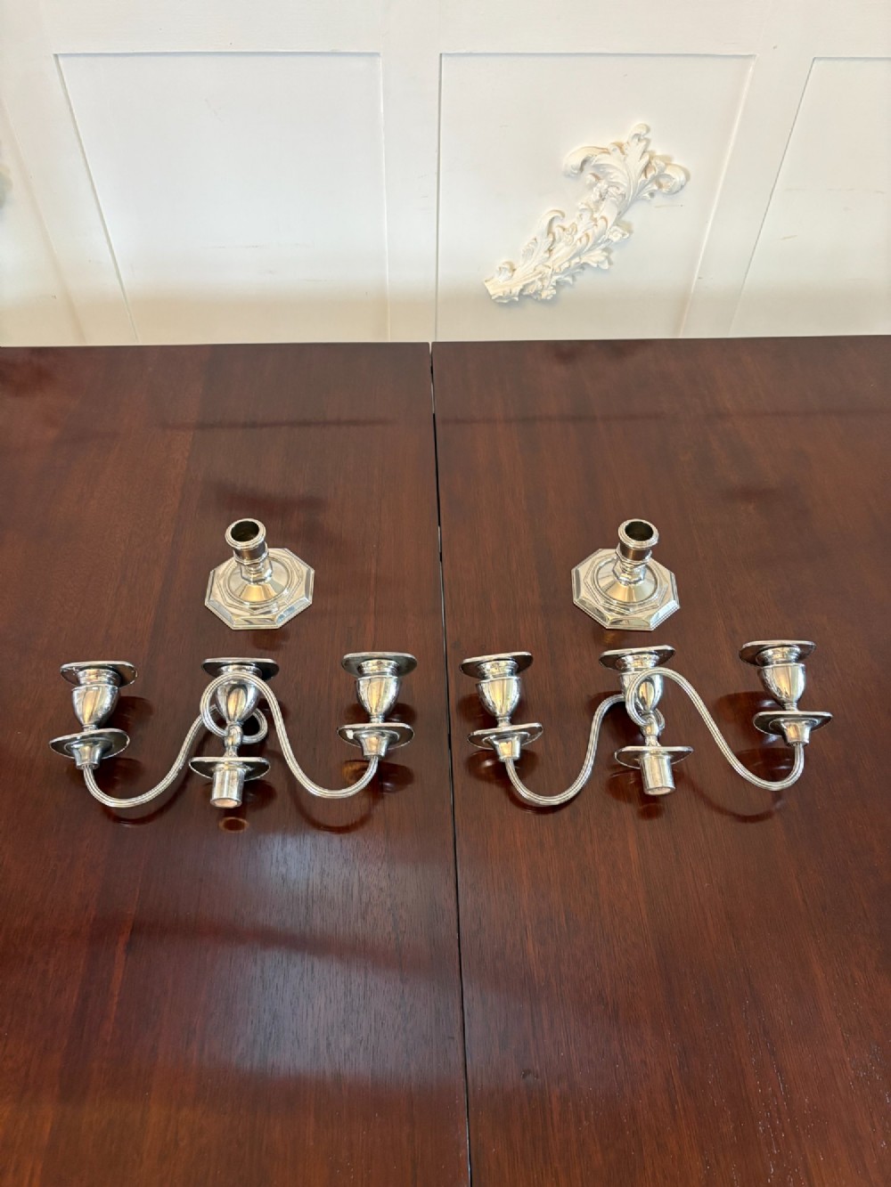 A matching pair of Edwardian silver plated three-light candelabras with octagonal bases and curved reeded arms. View VII