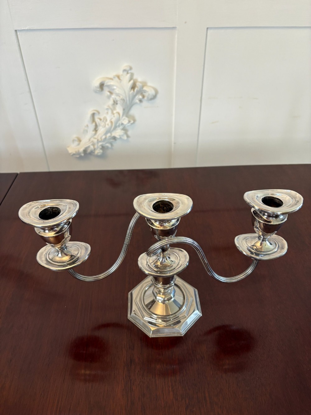 A matching pair of Edwardian silver plated three-light candelabras with octagonal bases and curved reeded arms. View VIII