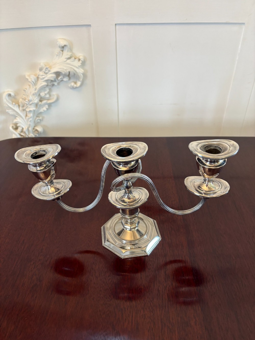 A matching pair of Edwardian silver plated three-light candelabras with octagonal bases and curved reeded arms. View IX