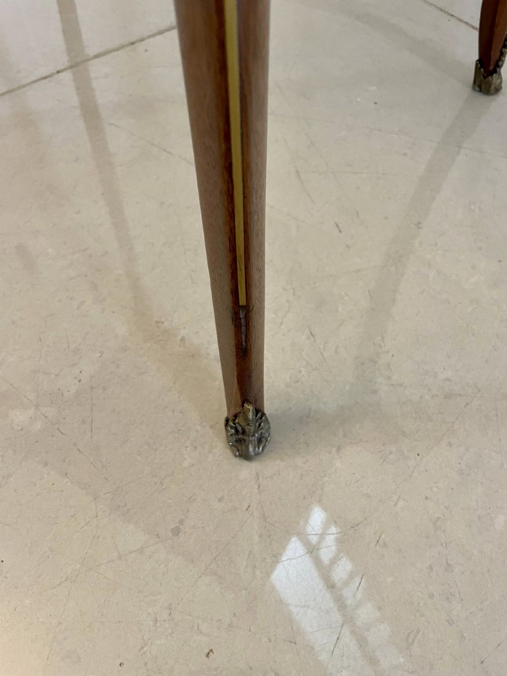 A 19th-century French mahogany bijouterie display table featuring a glazed top with brass inlay, a single front drawer, and slender cabriole legs with brass mounts. View VI