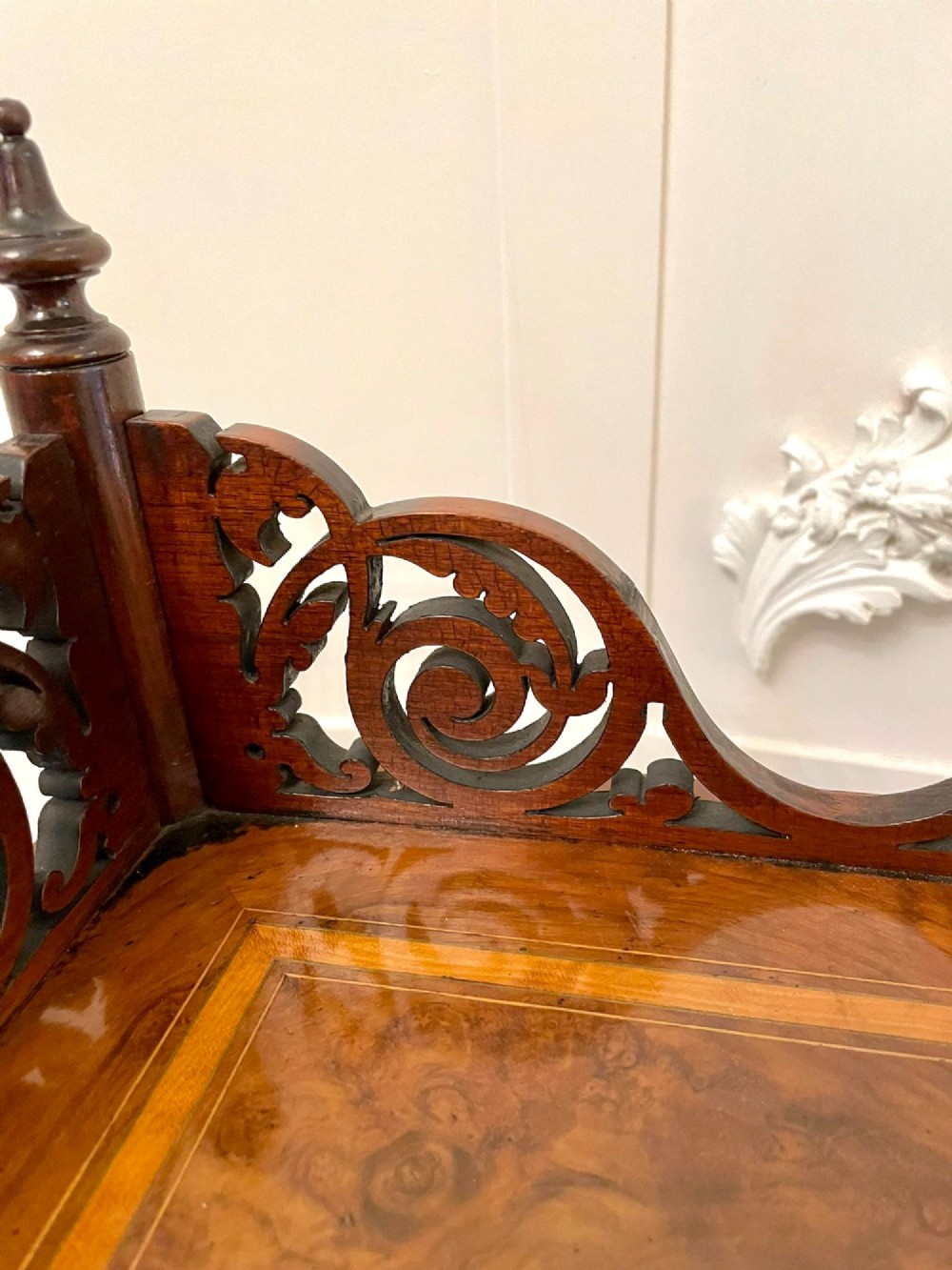 A four-tiered Victorian corner whatnot made of figured burr walnut featuring marquetry inlay, turned columns, and pierced fretwork crests. View IV