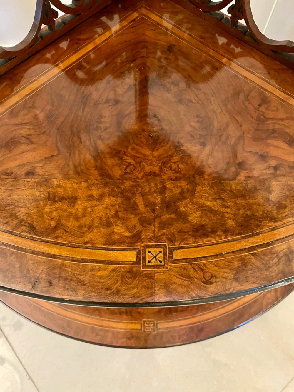 A four-tiered Victorian corner whatnot made of figured burr walnut featuring marquetry inlay, turned columns, and pierced fretwork crests. View IX