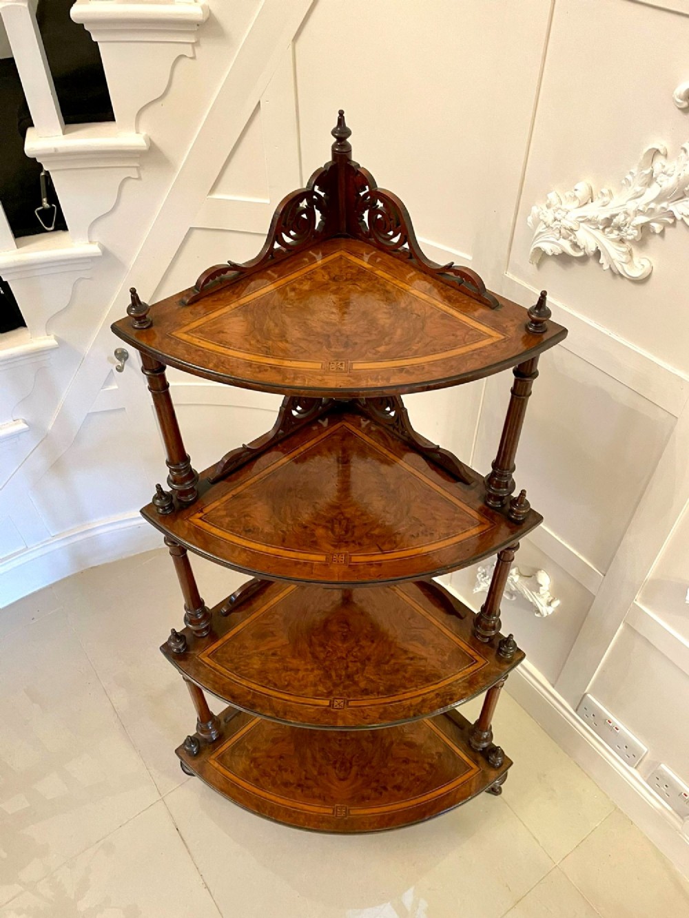 A four-tiered Victorian corner whatnot made of figured burr walnut featuring marquetry inlay, turned columns, and pierced fretwork crests. View XIII