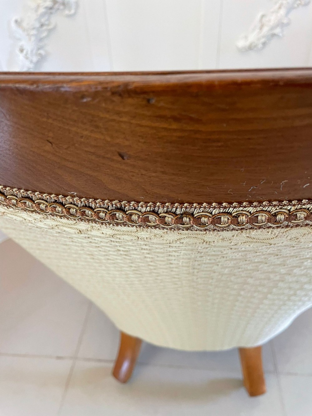 A pair of antique Victorian mahogany armchairs featuring carved show-frames, cream patterned upholstery, and turned front legs on castors. View II