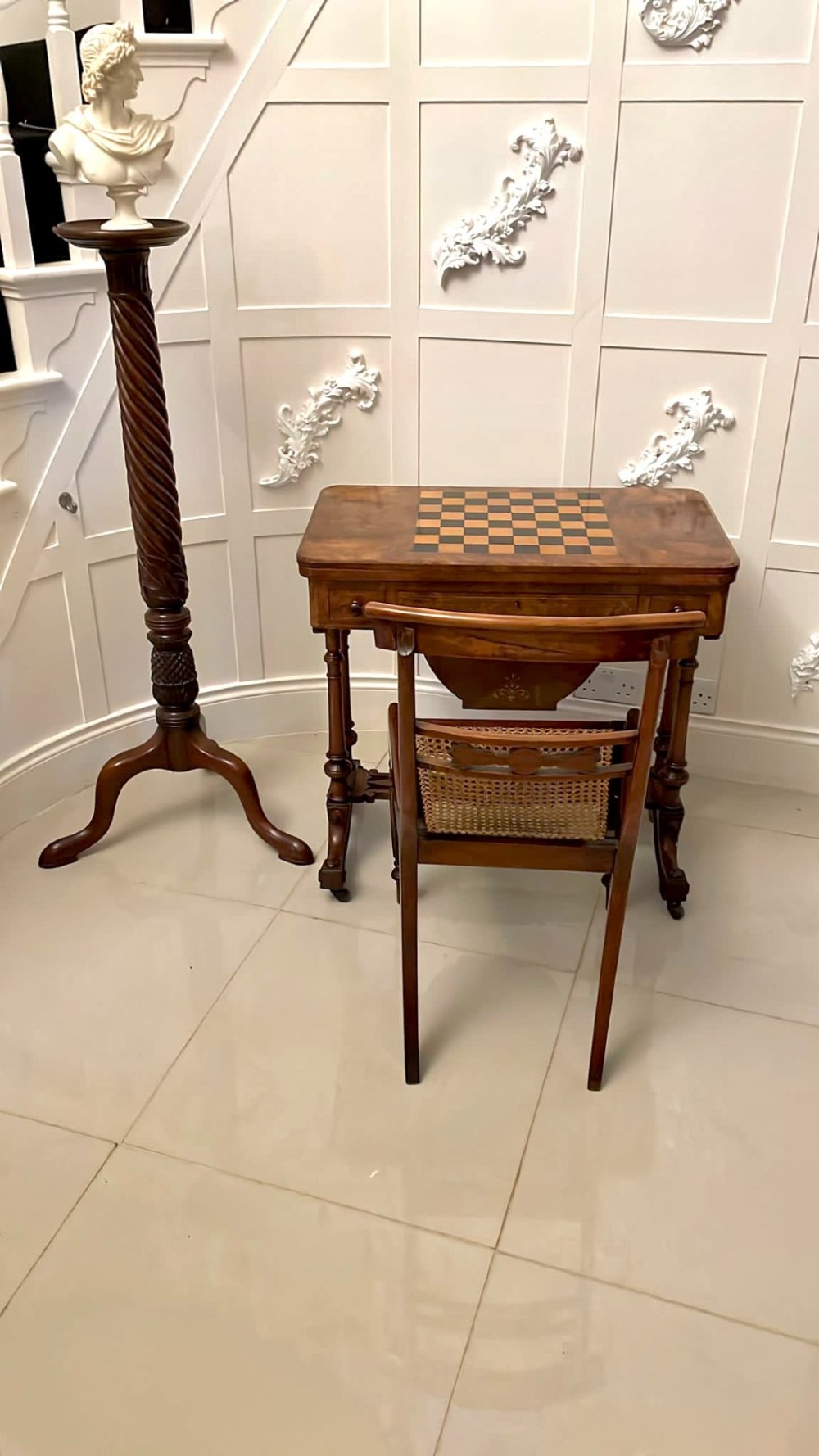 An antique Victorian burr walnut games table featuring an inlaid chessboard top, a frieze drawer, carved turned twin-column supports, and a pierced fretwork stretcher. View VIII