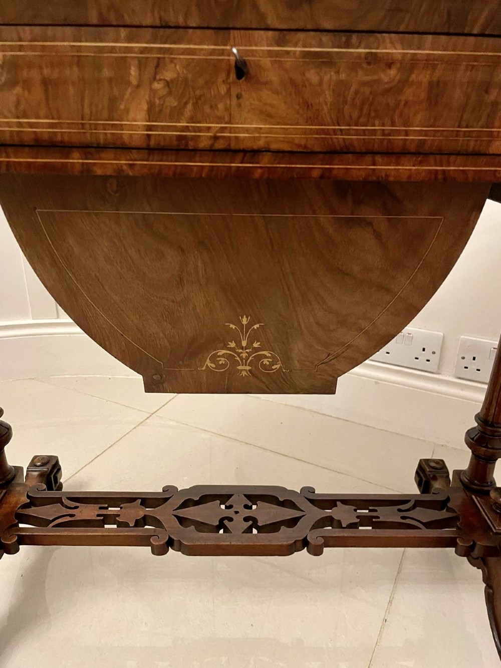 An antique Victorian burr walnut games table featuring an inlaid chessboard top, a frieze drawer, carved turned twin-column supports, and a pierced fretwork stretcher. View XIV
