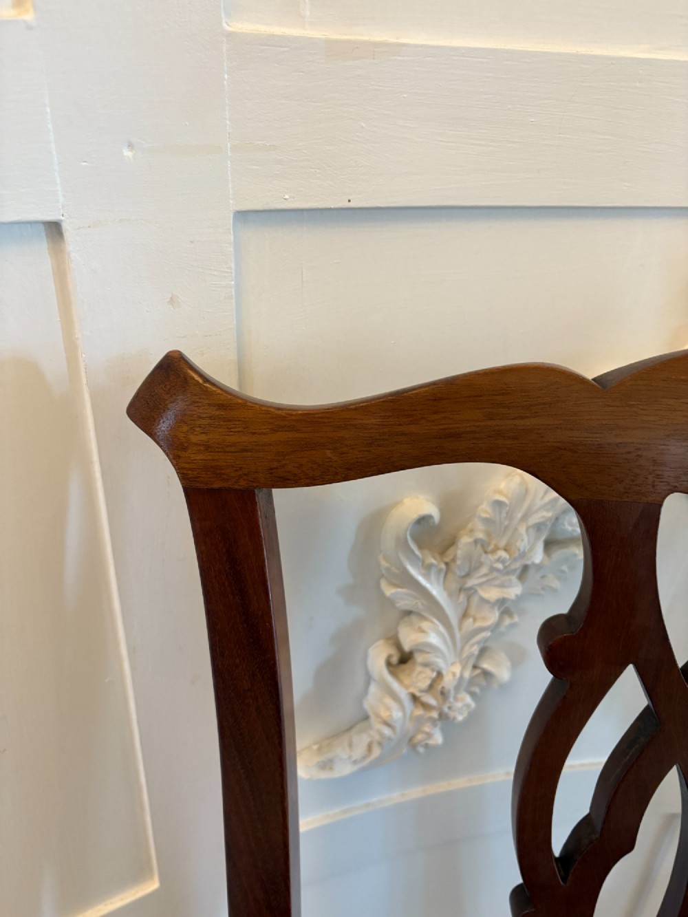 A set of eight Edwardian mahogany dining chairs featuring pierced fretwork splats and black velvet upholstered seats, comprising two carver armchairs and six side chairs. View XII