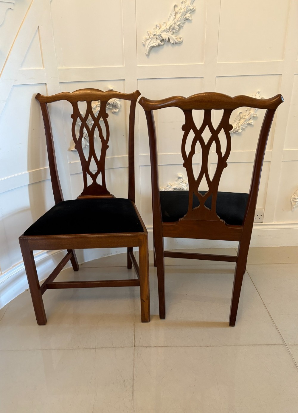 A set of eight Edwardian mahogany dining chairs featuring pierced fretwork splats and black velvet upholstered seats, comprising two carver armchairs and six side chairs. View XIII