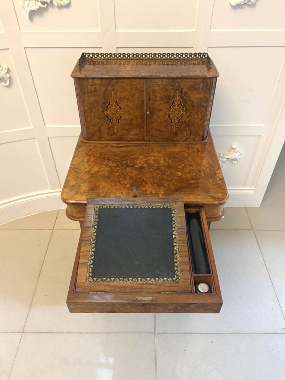 A Victorian burr walnut Davenport desk with floral marquetry inlay, a brass top gallery, and carved scroll feet. View X