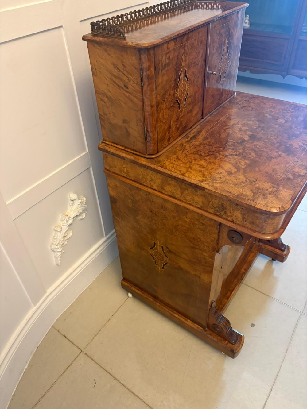 A Victorian burr walnut Davenport desk with floral marquetry inlay, a brass top gallery, and carved scroll feet. View XII