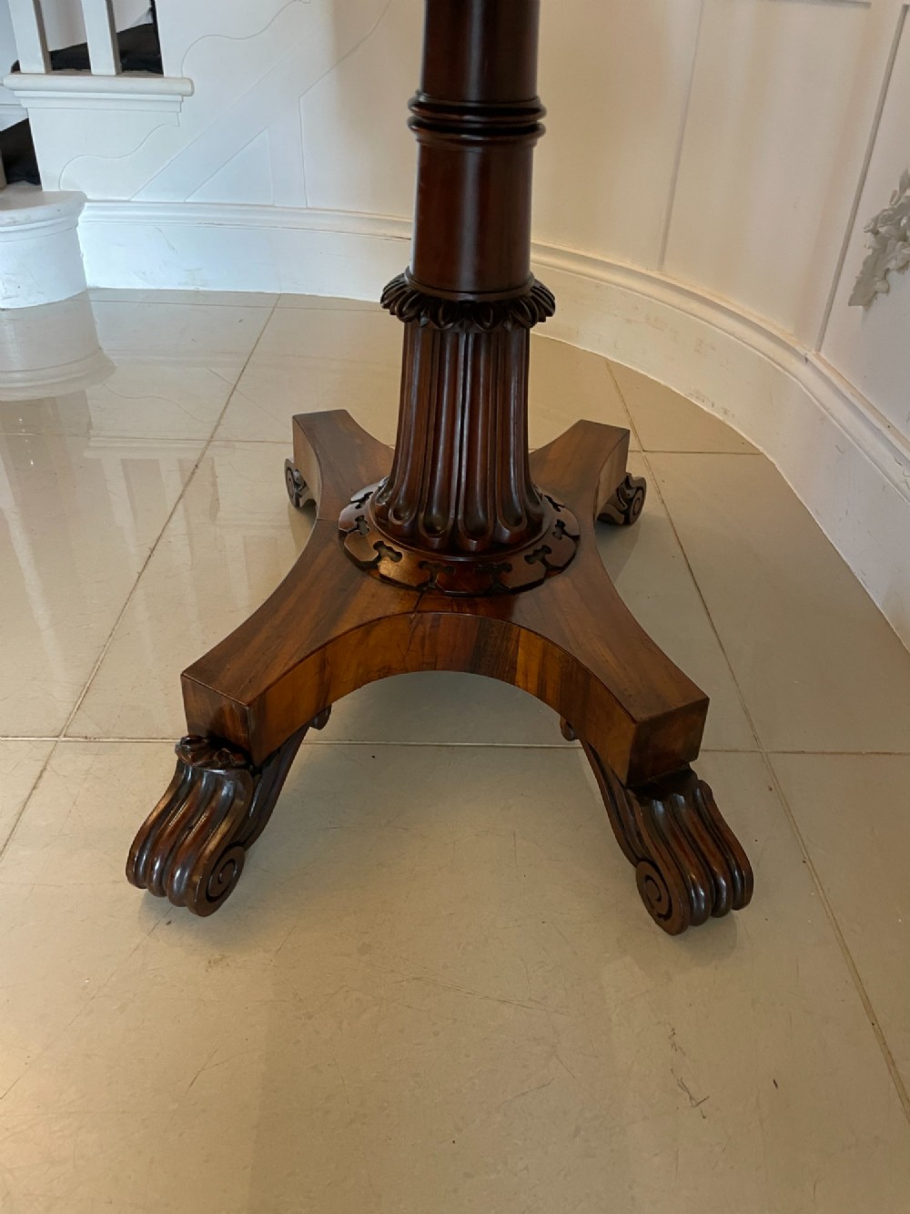 An antique Victorian rosewood fold-over card table featuring a carved frieze, a fluted pedestal column, and a quadform base with scroll feet. View VII