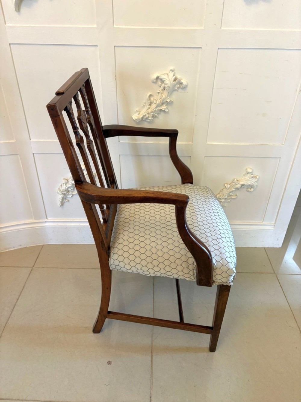 A set of eight dark mahogany Victorian dining chairs with carved backs and light geometric patterned upholstered seats, including two carvers with armrests. View IV