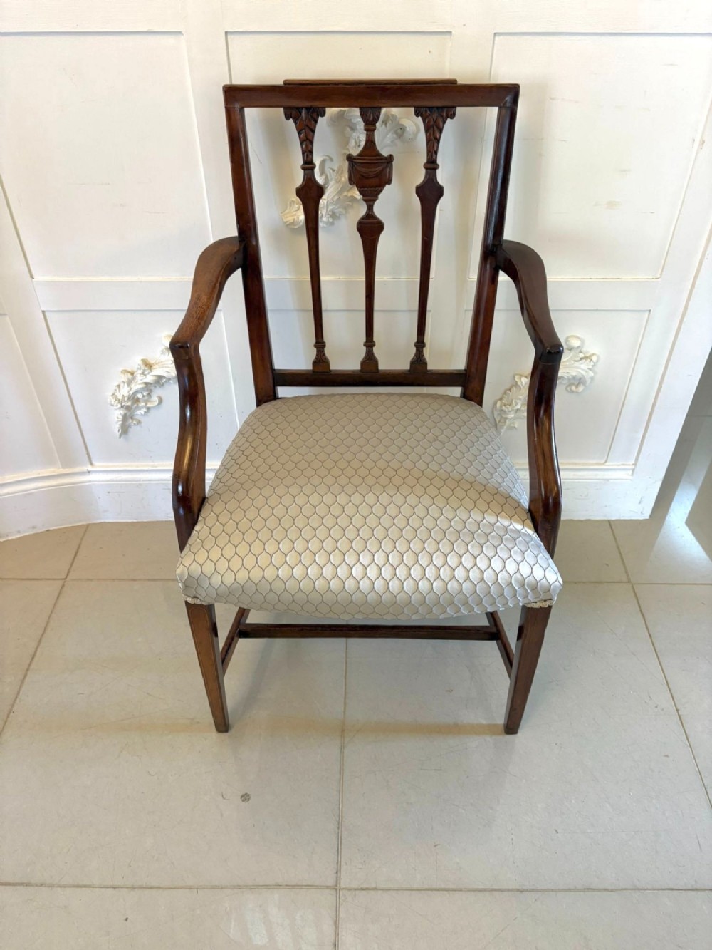 A set of eight dark mahogany Victorian dining chairs with carved backs and light geometric patterned upholstered seats, including two carvers with armrests. View VII