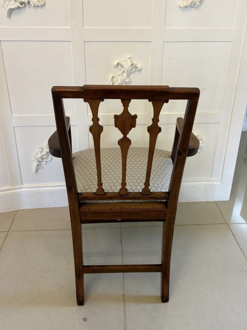 A set of eight dark mahogany Victorian dining chairs with carved backs and light geometric patterned upholstered seats, including two carvers with armrests. View VIII