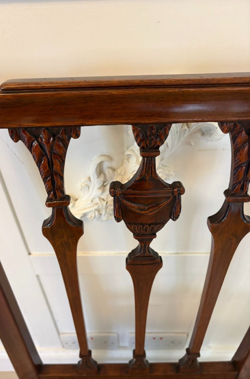 A set of eight dark mahogany Victorian dining chairs with carved backs and light geometric patterned upholstered seats, including two carvers with armrests. View IX