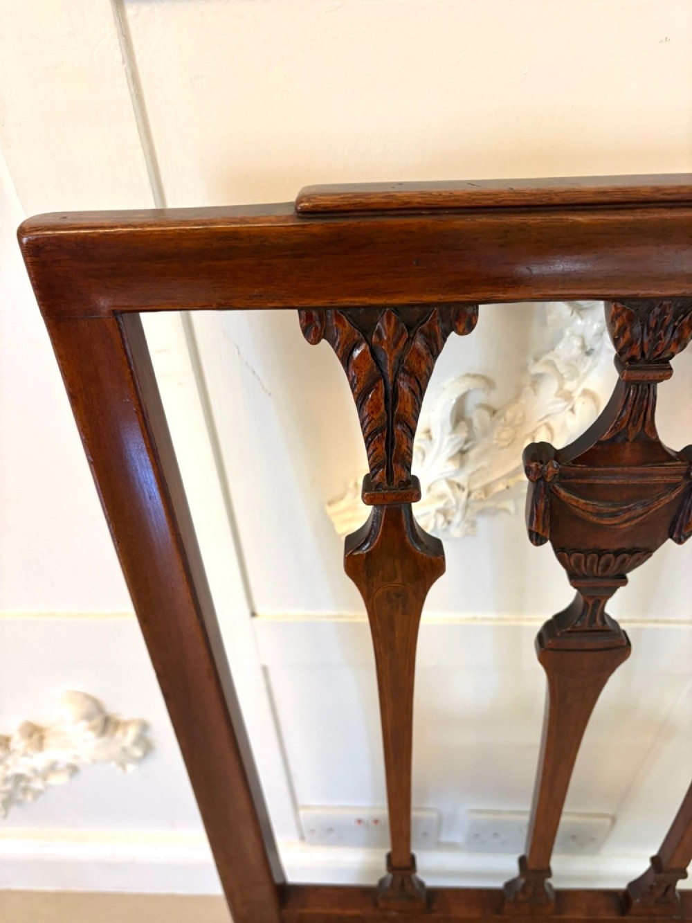 A set of eight dark mahogany Victorian dining chairs with carved backs and light geometric patterned upholstered seats, including two carvers with armrests. View X