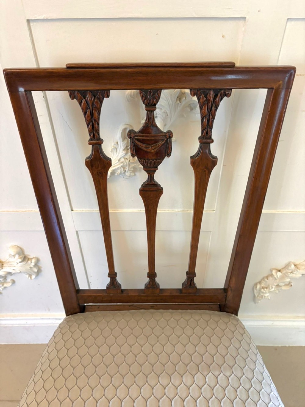 A set of eight dark mahogany Victorian dining chairs with carved backs and light geometric patterned upholstered seats, including two carvers with armrests. View XI
