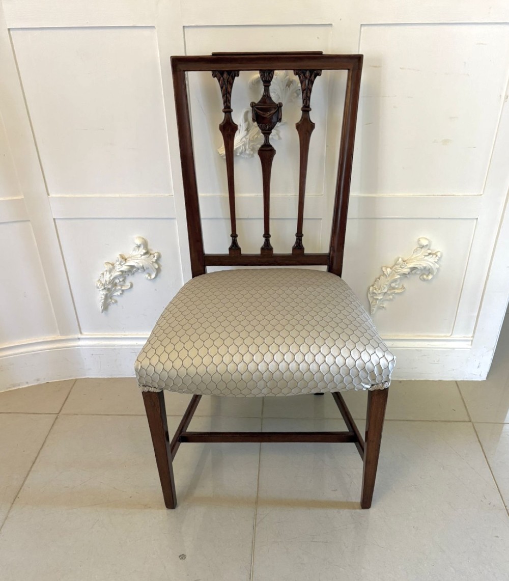 A set of eight dark mahogany Victorian dining chairs with carved backs and light geometric patterned upholstered seats, including two carvers with armrests. View XII