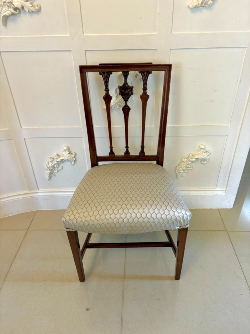 A set of eight dark mahogany Victorian dining chairs with carved backs and light geometric patterned upholstered seats, including two carvers with armrests. View XIII