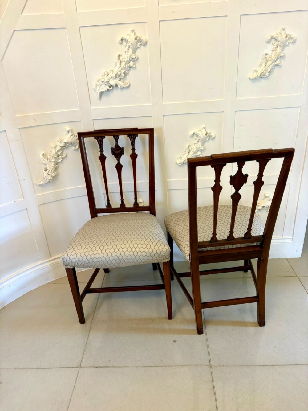 A set of eight dark mahogany Victorian dining chairs with carved backs and light geometric patterned upholstered seats, including two carvers with armrests. View XIV