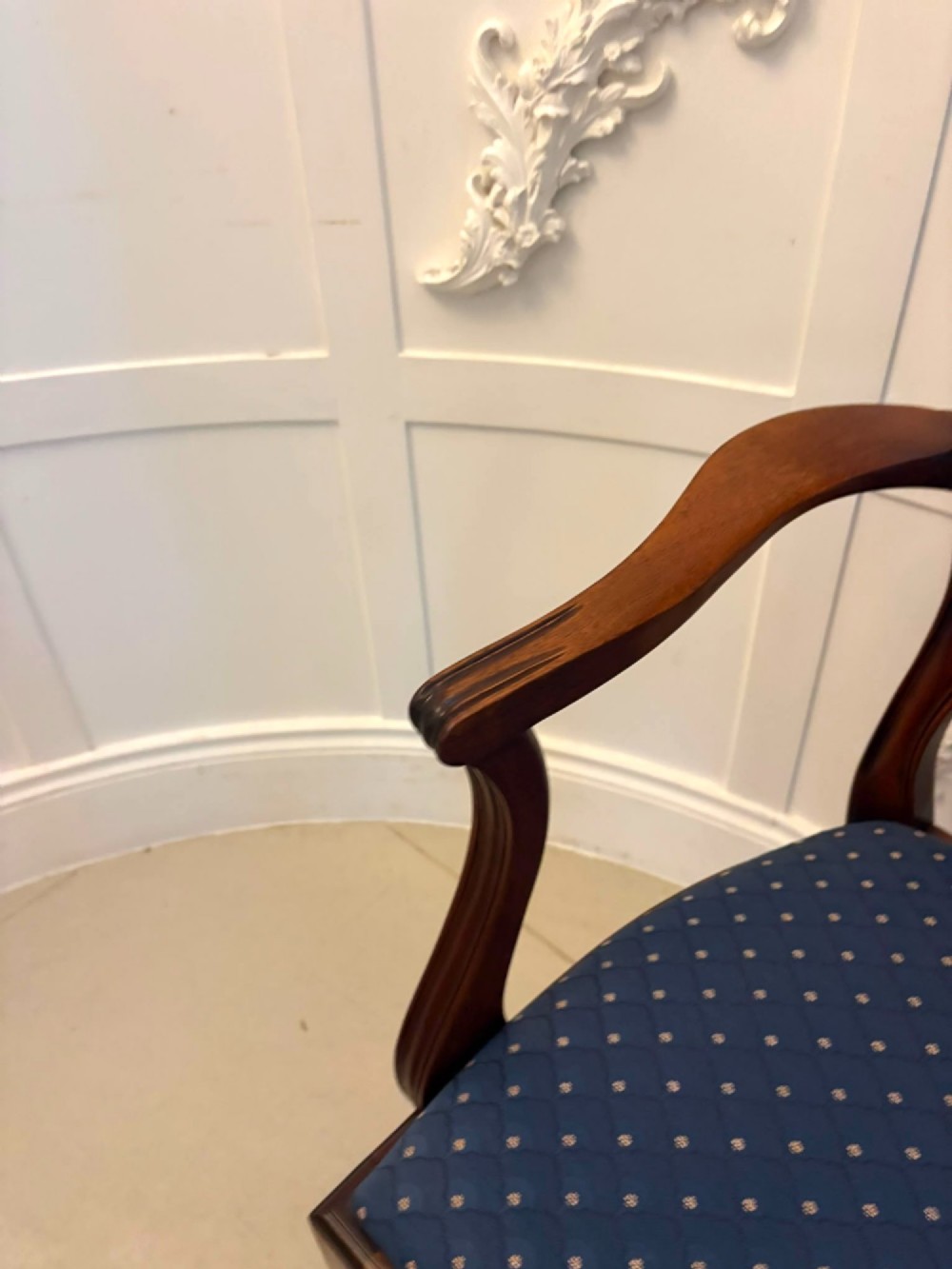 A set of twelve mahogany shield back dining chairs featuring carved backrest splats, square tapered legs, and blue patterned upholstered seats. View V