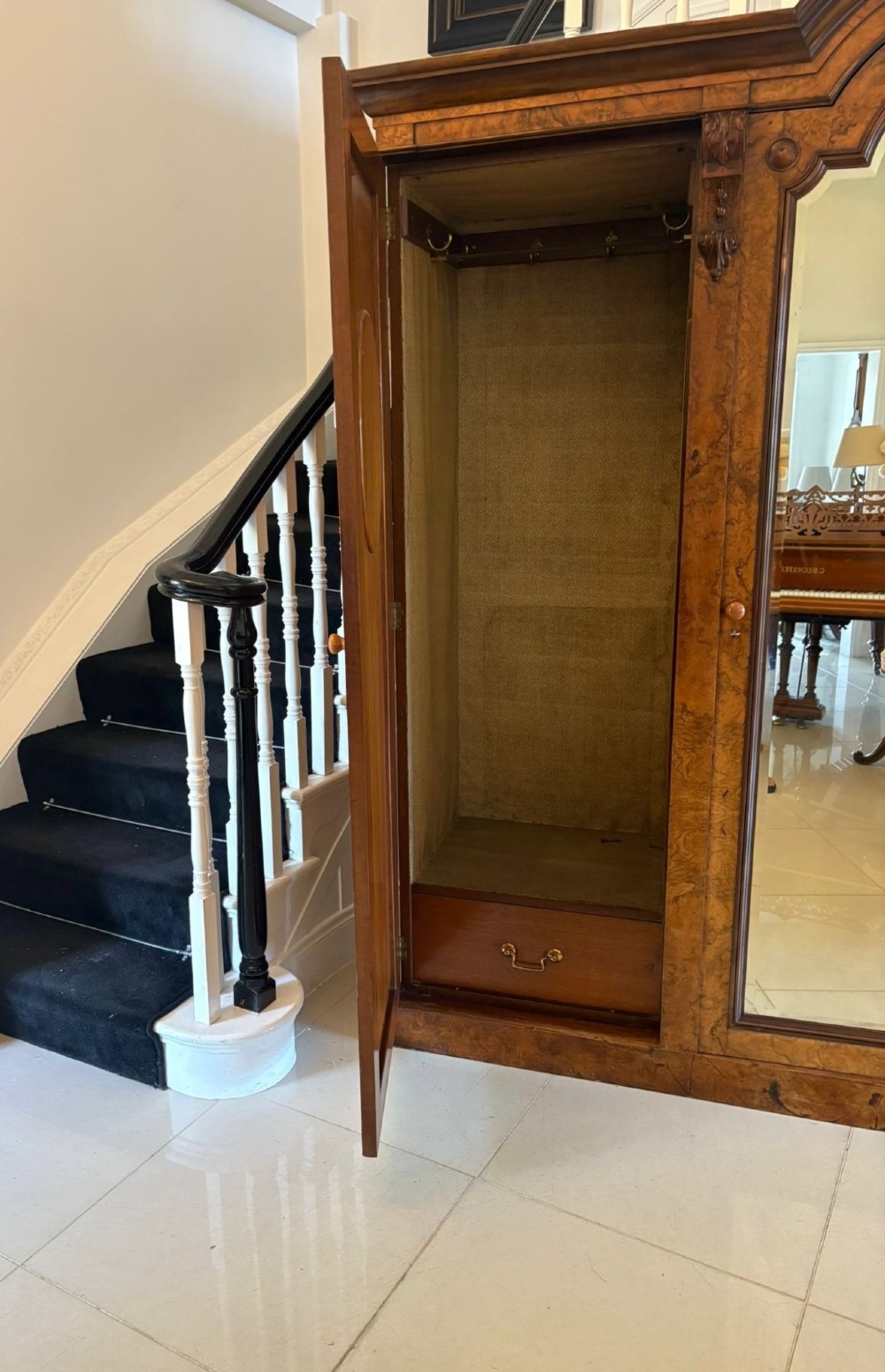 A large Victorian burr walnut three-door wardrobe with a central arched mirrored door, oval mirrors set into side panels, and carved pediment details. View III