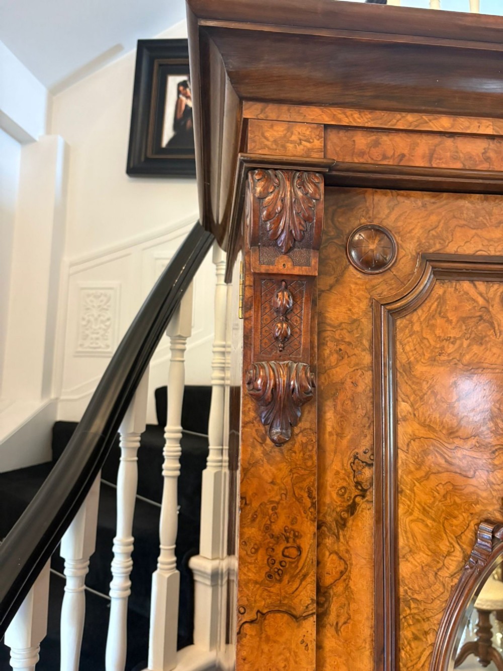 A large Victorian burr walnut three-door wardrobe with a central arched mirrored door, oval mirrors set into side panels, and carved pediment details. View VIII