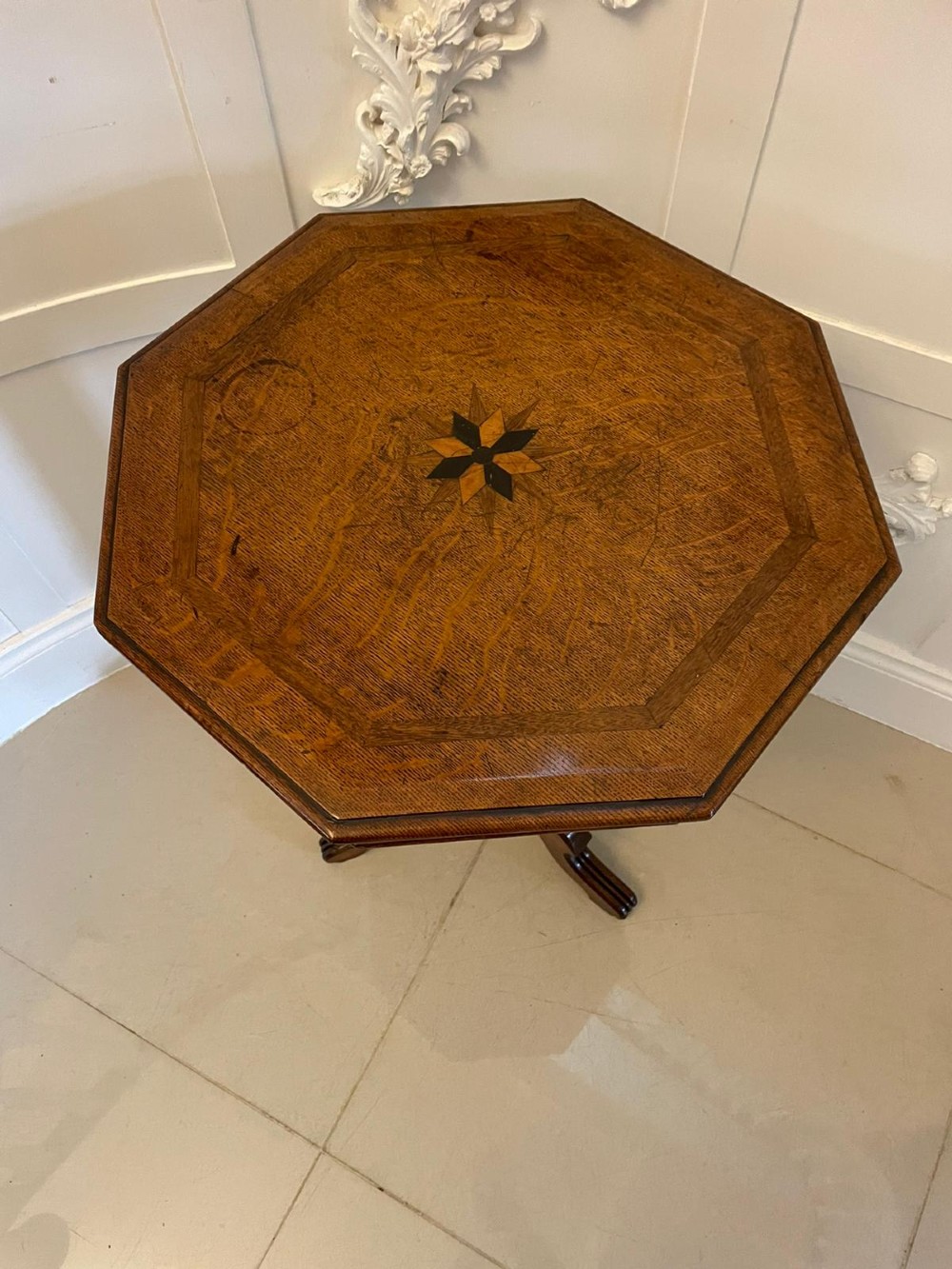 A Victorian octagonal oak lamp table featuring a central star marquetry inlay, a faceted pedestal column, and three carved tripod legs. View II