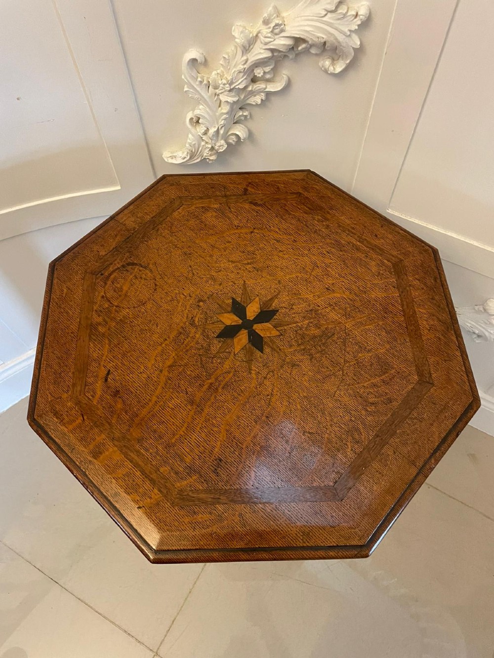 A Victorian octagonal oak lamp table featuring a central star marquetry inlay, a faceted pedestal column, and three carved tripod legs. View III