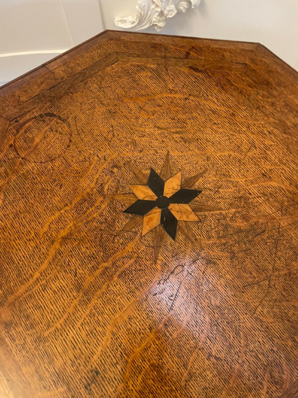 A Victorian octagonal oak lamp table featuring a central star marquetry inlay, a faceted pedestal column, and three carved tripod legs. View IV