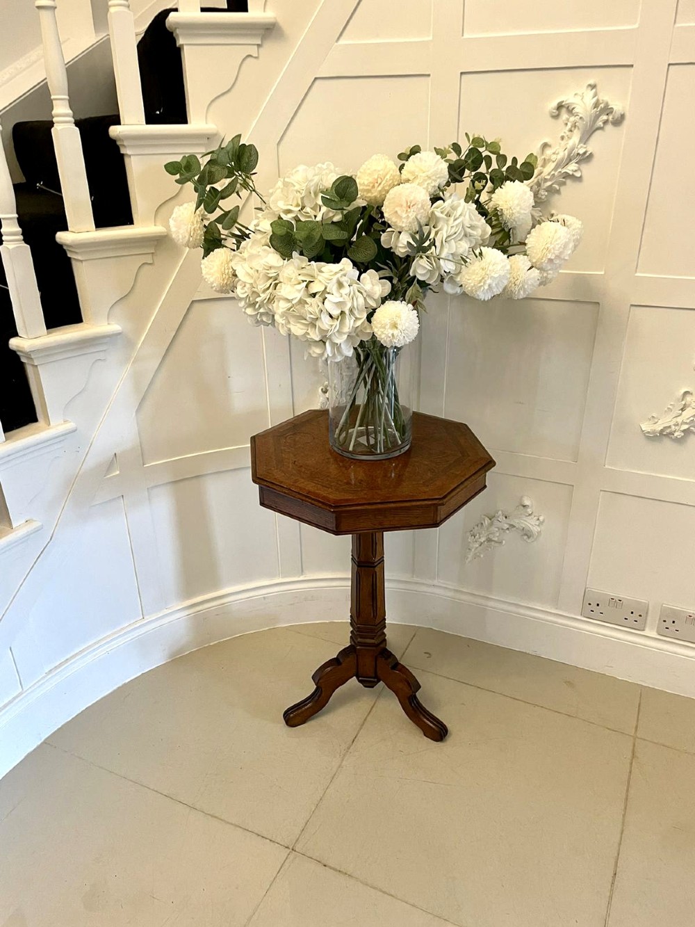 A Victorian octagonal oak lamp table featuring a central star marquetry inlay, a faceted pedestal column, and three carved tripod legs. View V