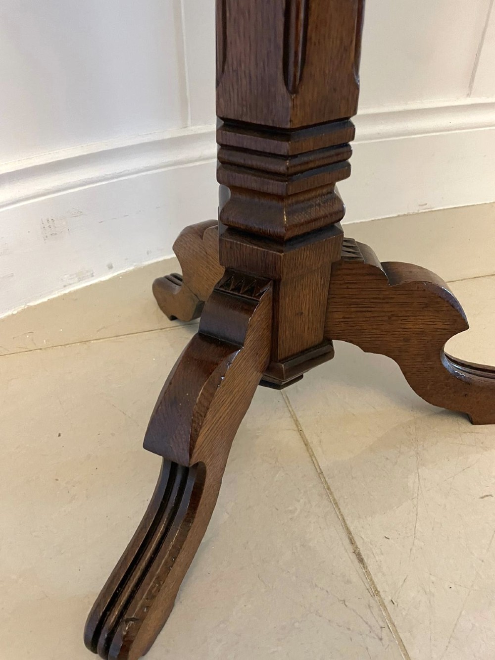 A Victorian octagonal oak lamp table featuring a central star marquetry inlay, a faceted pedestal column, and three carved tripod legs. View VII