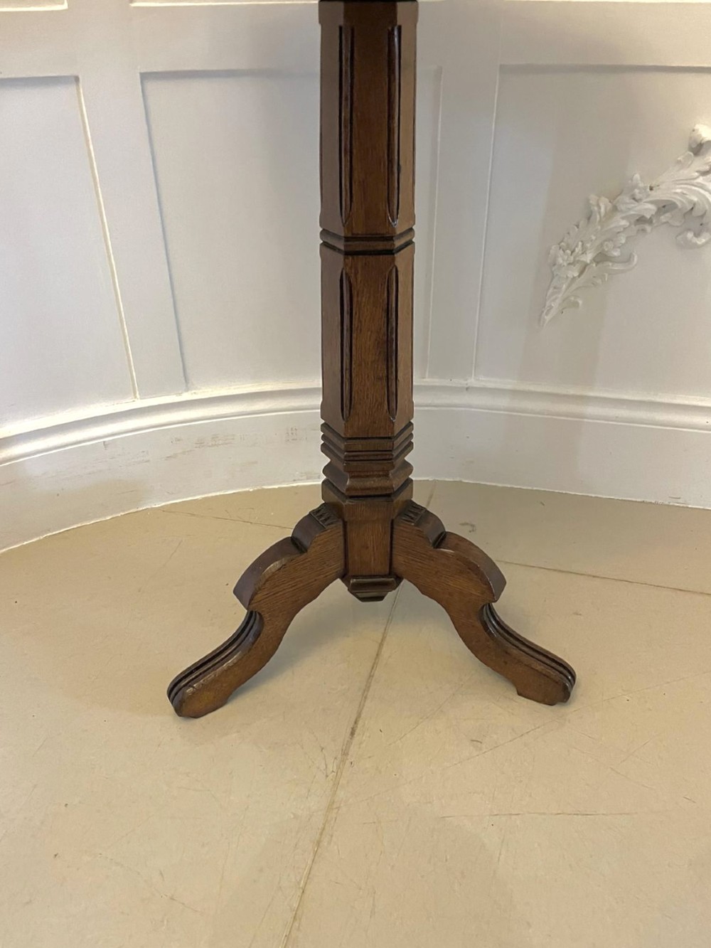 A Victorian octagonal oak lamp table featuring a central star marquetry inlay, a faceted pedestal column, and three carved tripod legs. View XI