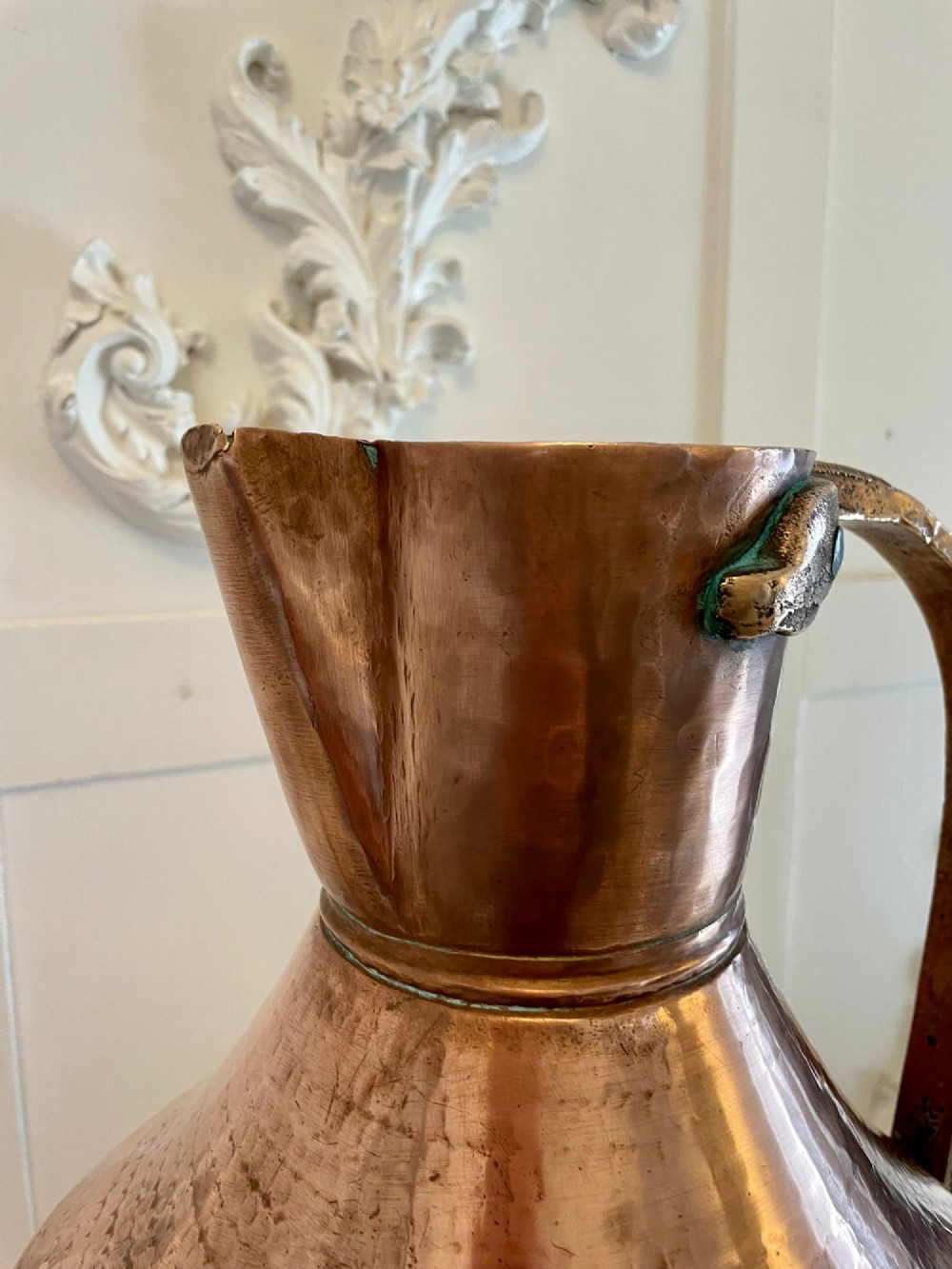 A large George III hand-hammered copper water jug featuring a flared base, narrow neck, and riveted strap handle. View II