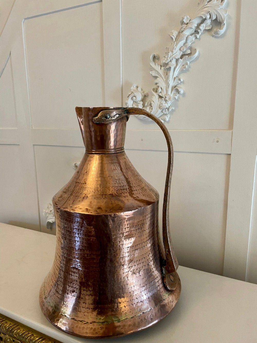 A large George III hand-hammered copper water jug featuring a flared base, narrow neck, and riveted strap handle. View V