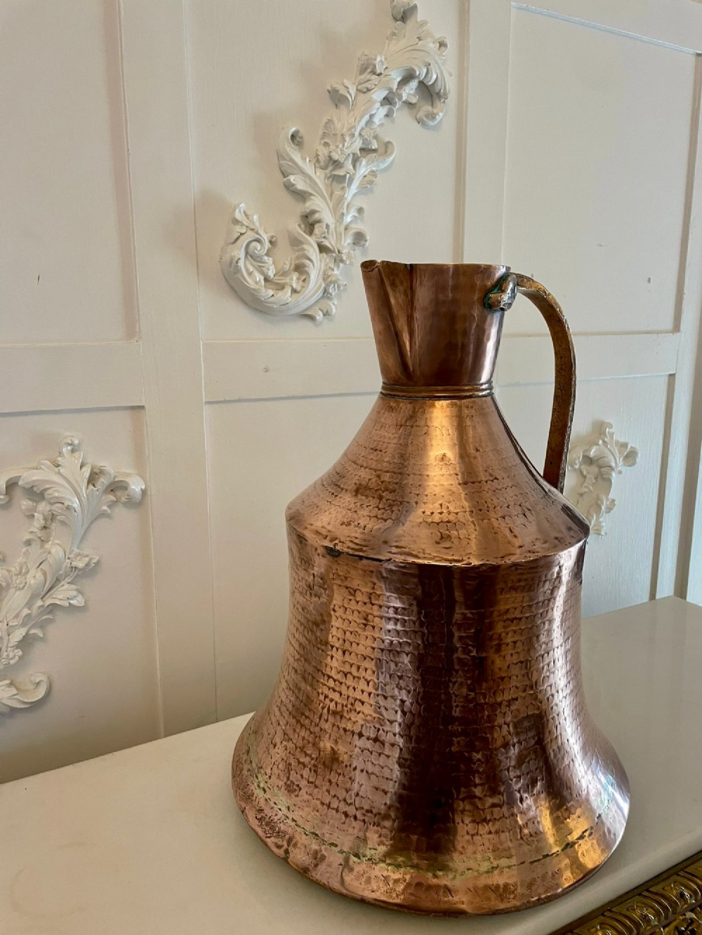 A large George III hand-hammered copper water jug featuring a flared base, narrow neck, and riveted strap handle. View VI