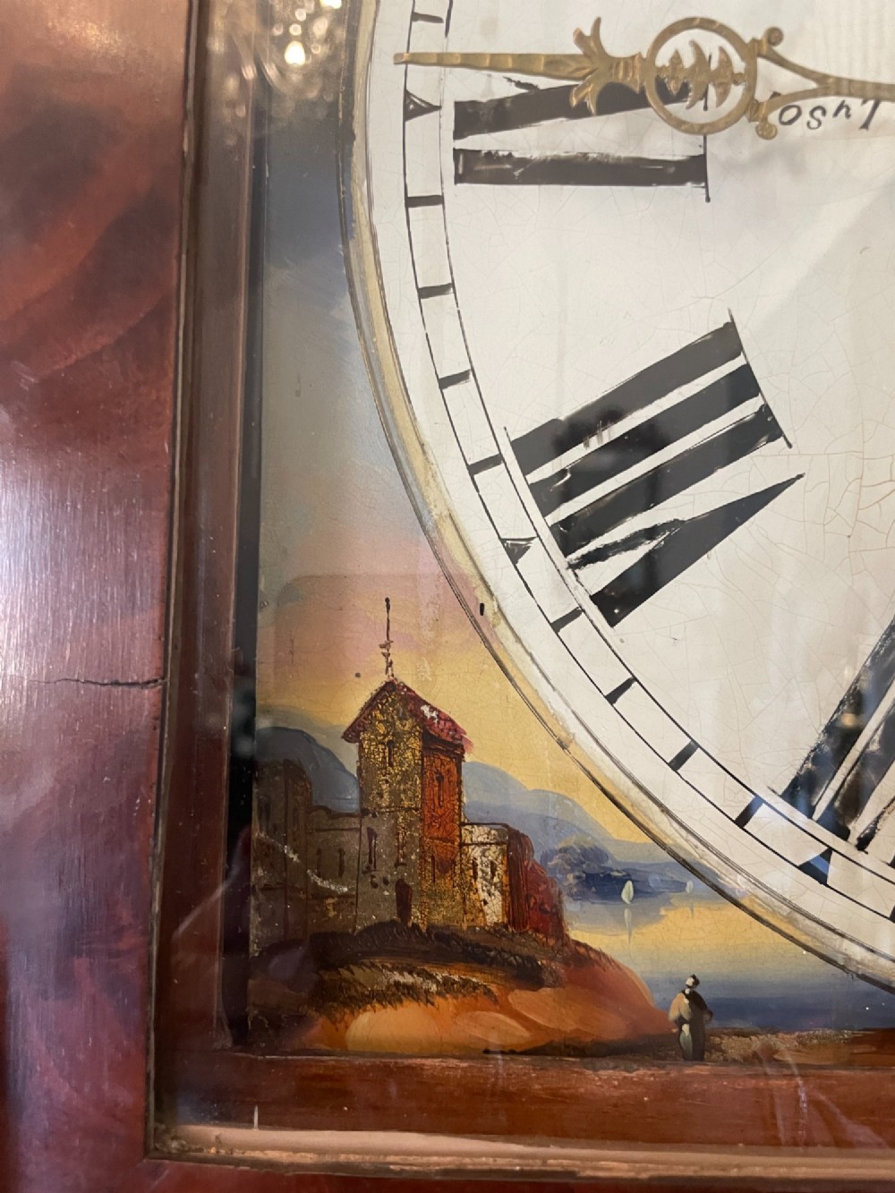 A George III flame mahogany longcase clock featuring a swan-neck pediment, turned hood columns, a painted arch dial, and a gothic-arched trunk door. View VIII