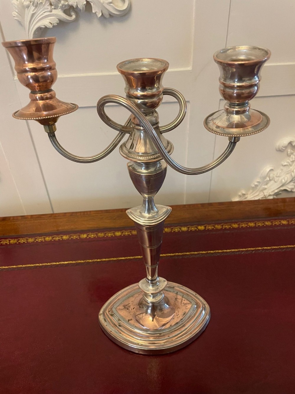A pair of antique silver-plated three-light candelabras with curved branch arms, tapered baluster stems, and moulded oval bases showing subtle copper undertones. View II